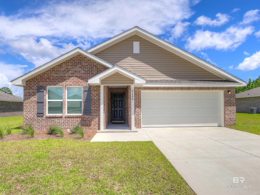 View of front of home with a garage and a front lawn