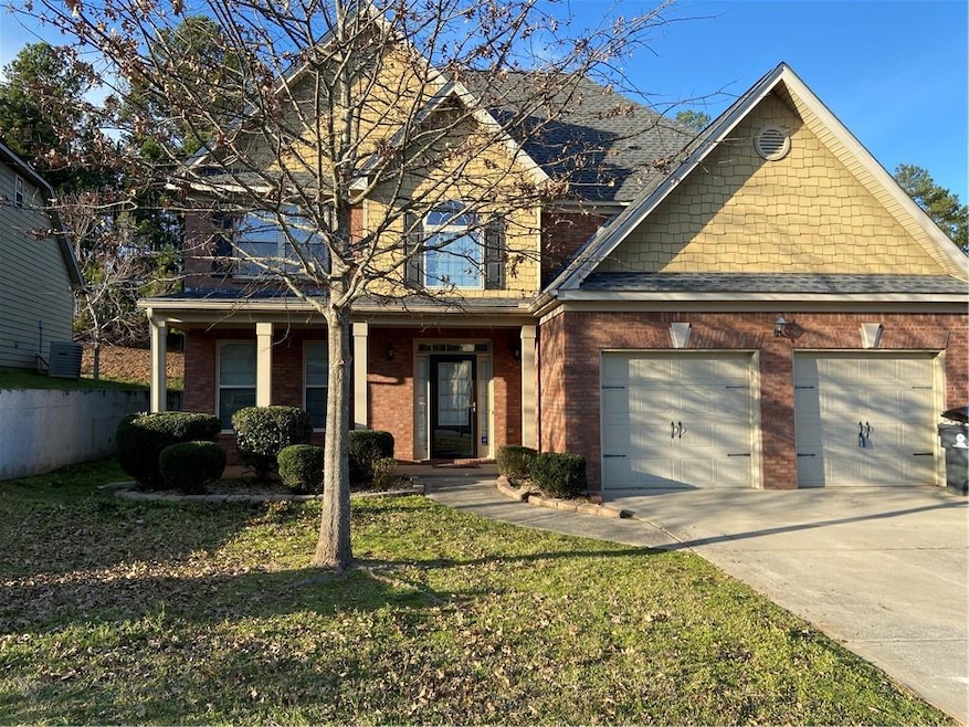 View of front of home featuring a garage, covered 