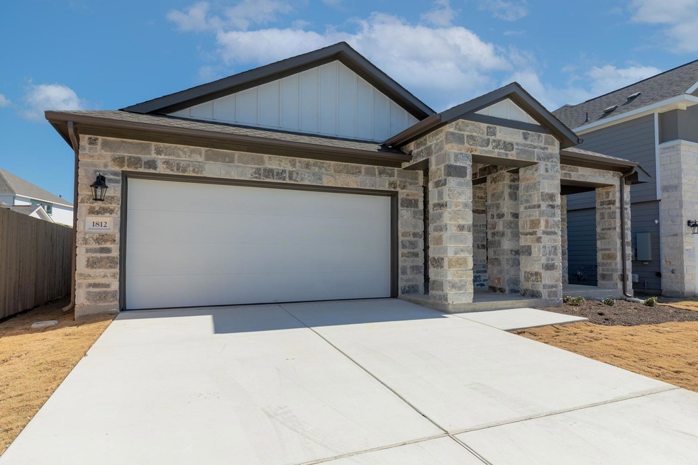 View of front of house featuring concrete drivewa