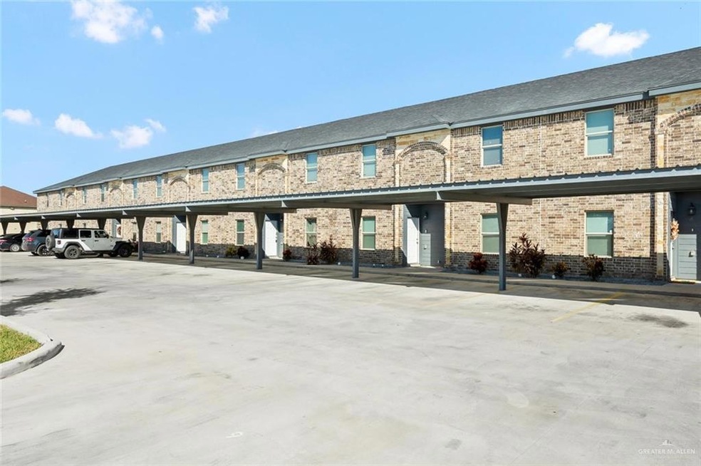 View of property with covered parking