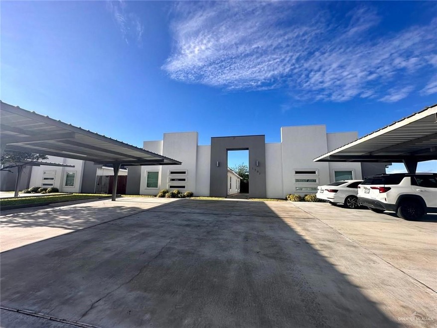 View of front of home featuring stucco siding and covered parking