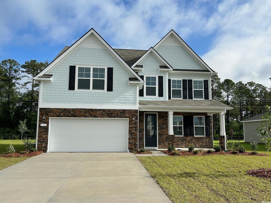 Craftsman-style home with concrete driveway, a fro