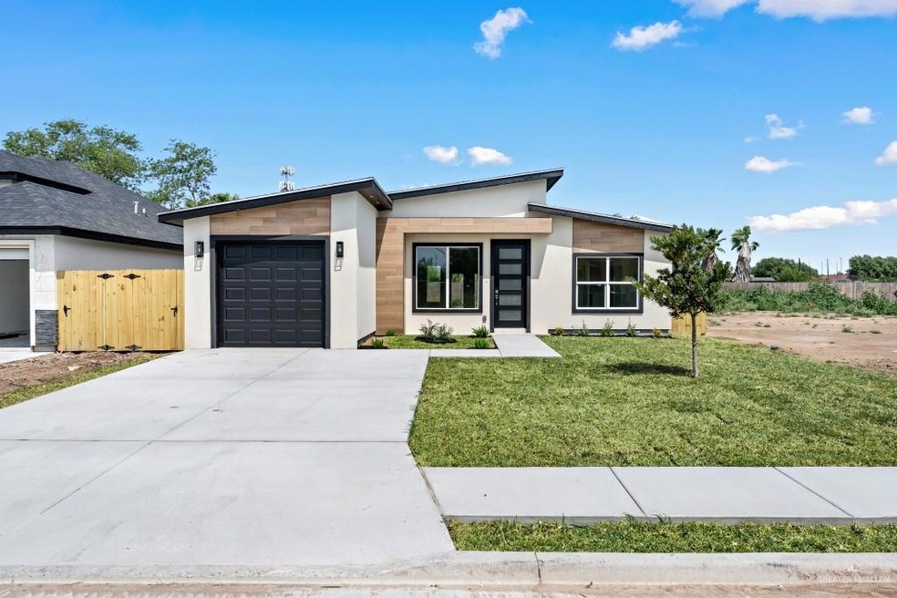 View of front of house with a front lawn and a garage