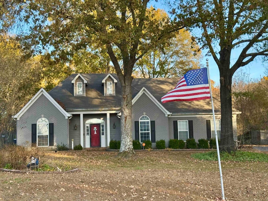 Cape cod home with brick siding and a porch