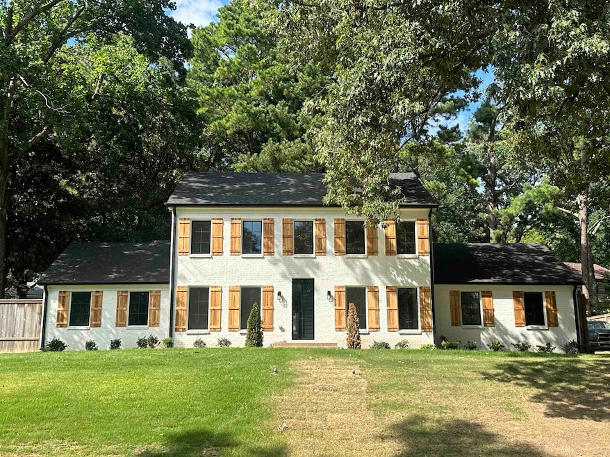 Colonial home featuring a front lawn