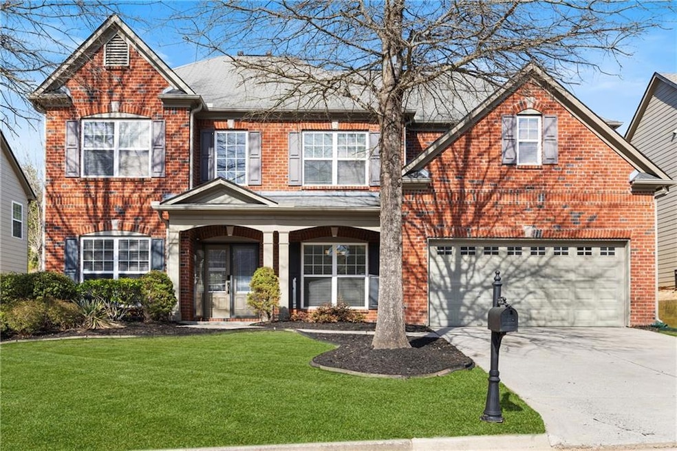 View of front of property featuring driveway, bric