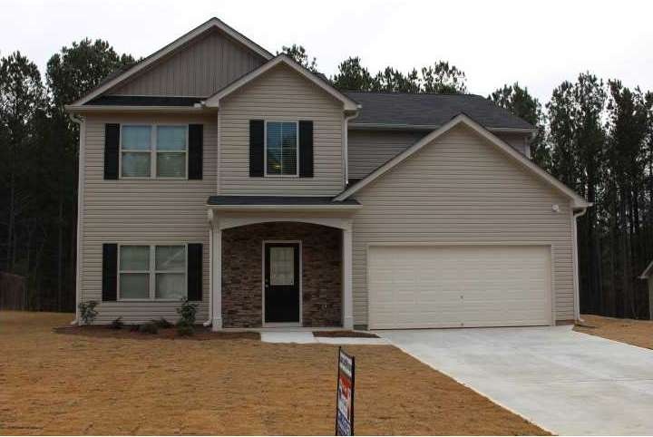 Exterior Front. Vinyl siding with stone front