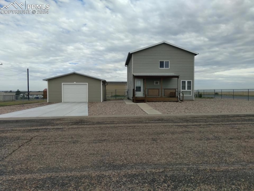 View of front facade with a garage, an outbuilding