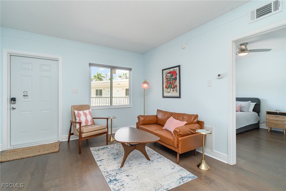 Living area with LVP flooring, midcentury modern f