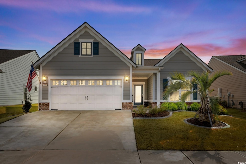 View of front of home featuring brick siding, concrete driveway, and a front lawn