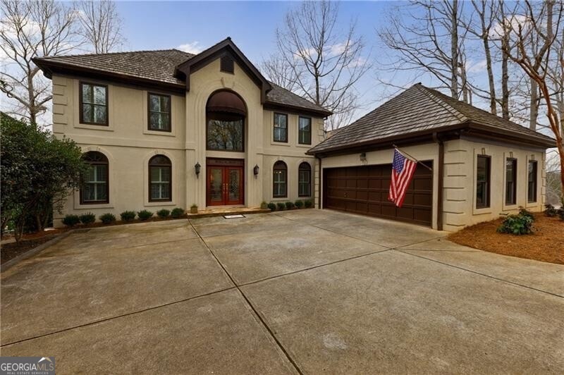 View of front of property featuring a garage and f