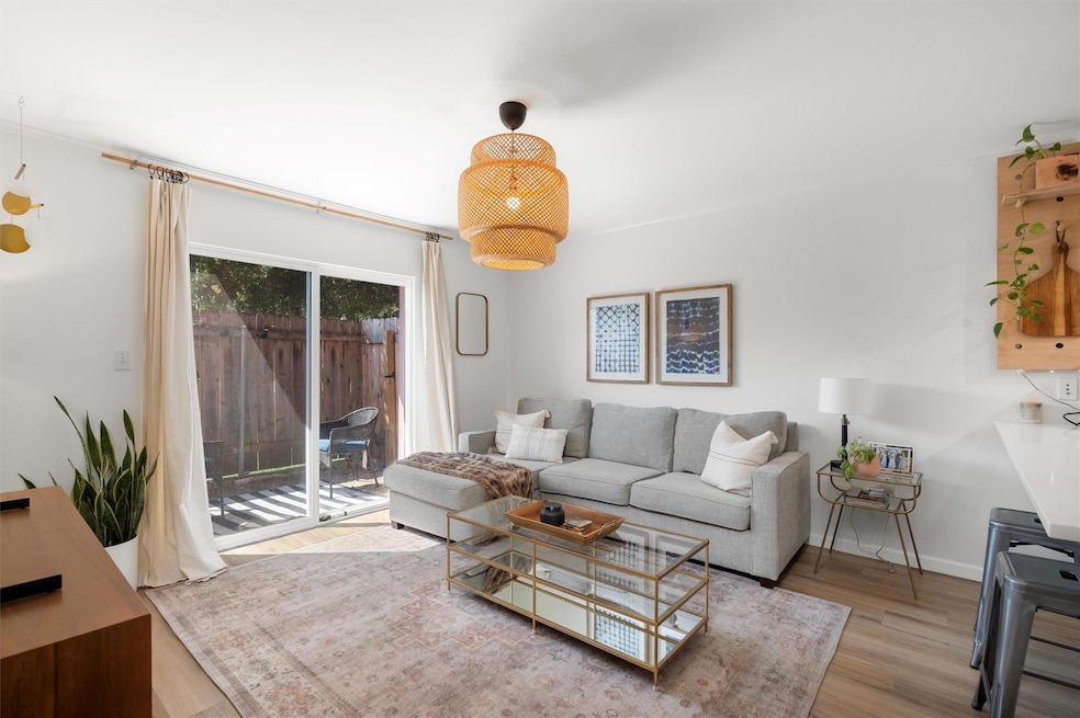 Living room with wood finished floors and baseboa
