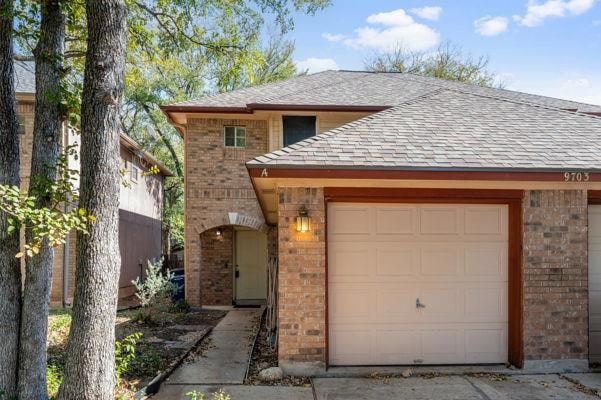 View of front of home featuring brick siding and 