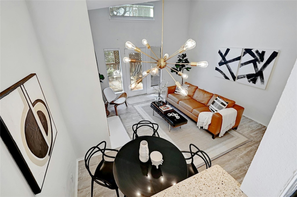 Living area featuring baseboards, a notable chand