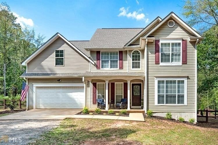 Gorgeous home with front porch and gated driveway.