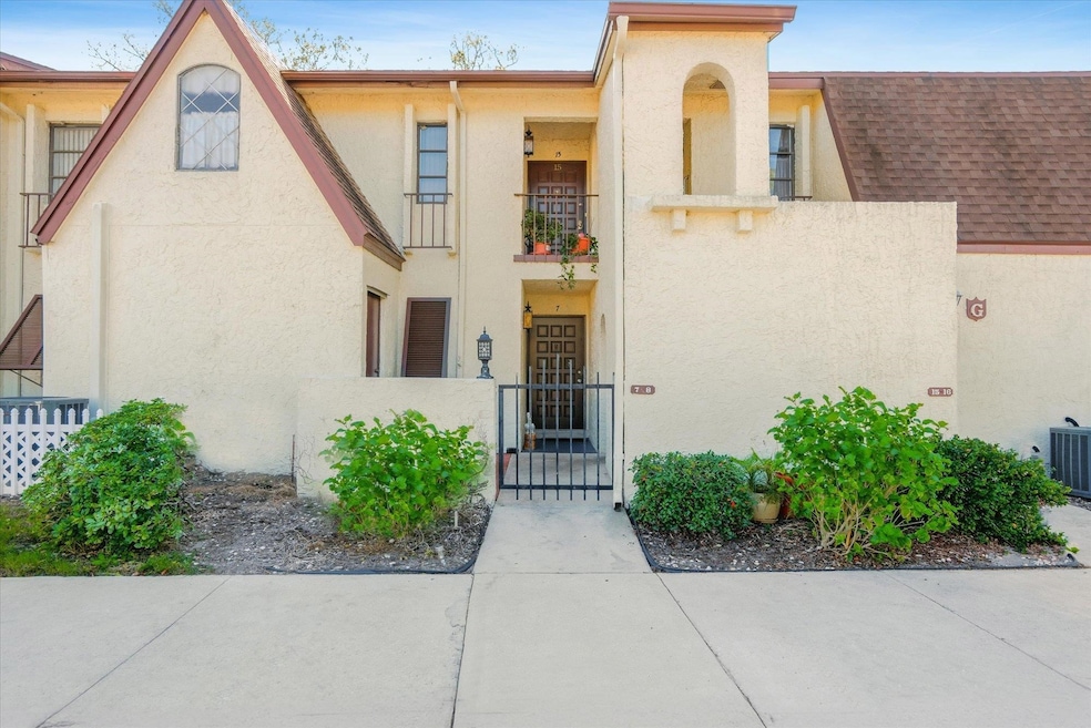 View of front of house with a fenced front yard, a gate, stucco siding, and a balcony