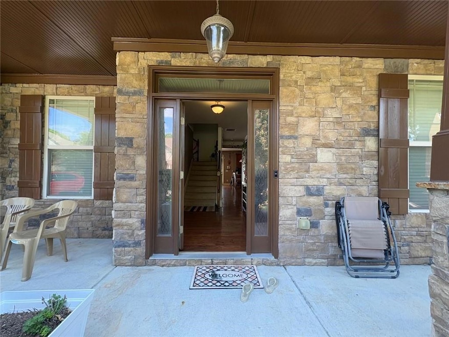 Entrance to property with stone siding