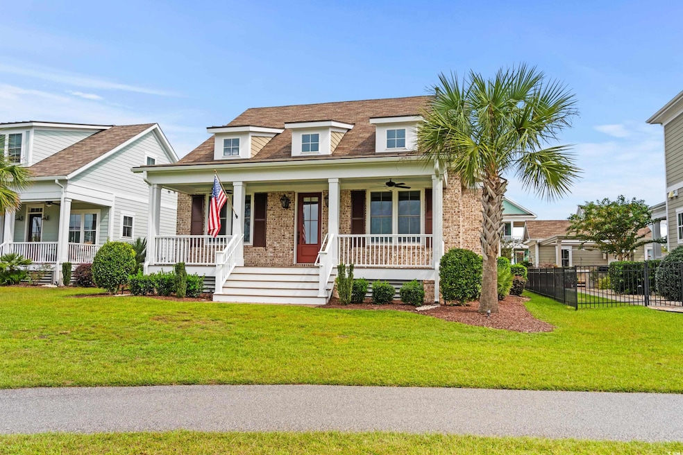 View of front facade with a front lawn and covered