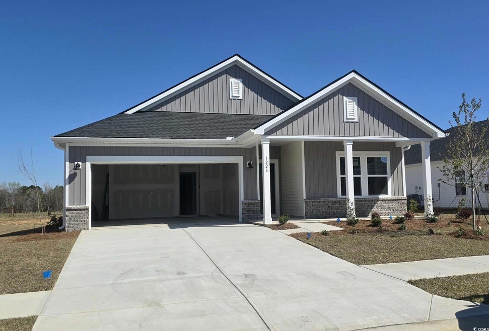 Craftsman-style house with an attached garage, dri