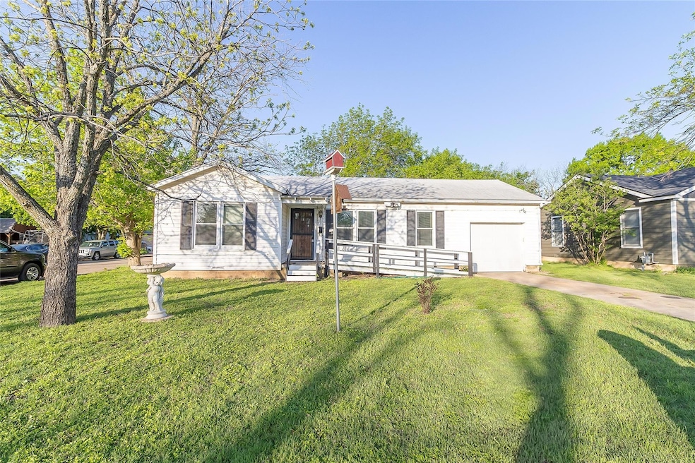 Ranch-style home featuring an attached garage, dri