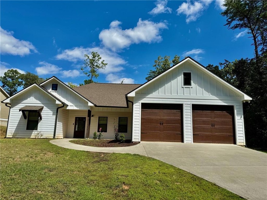 View of front facade featuring a garage and a fron