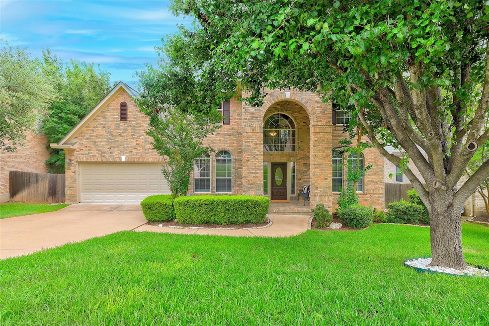 Traditional home featuring concrete driveway, a g