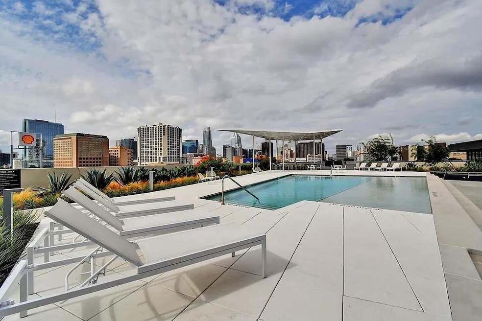 Community pool featuring a patio area and a skyli