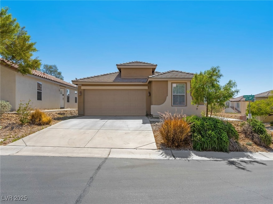 View of front of house with a garage, stucco sidin