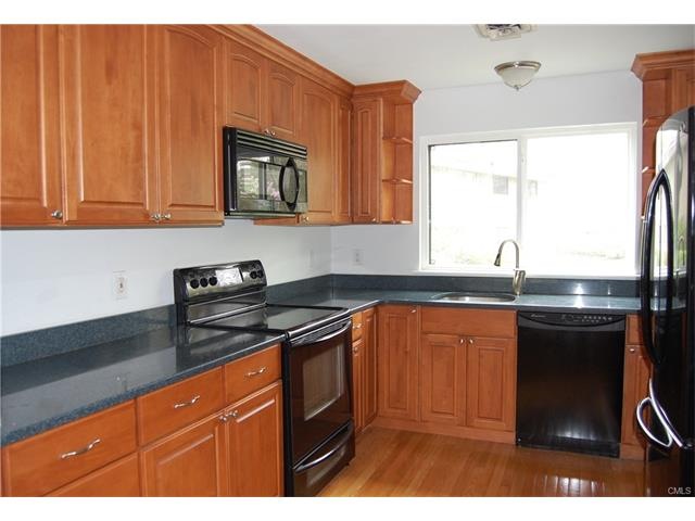 Updated eat-in kitchen with cherry cabinets, quart