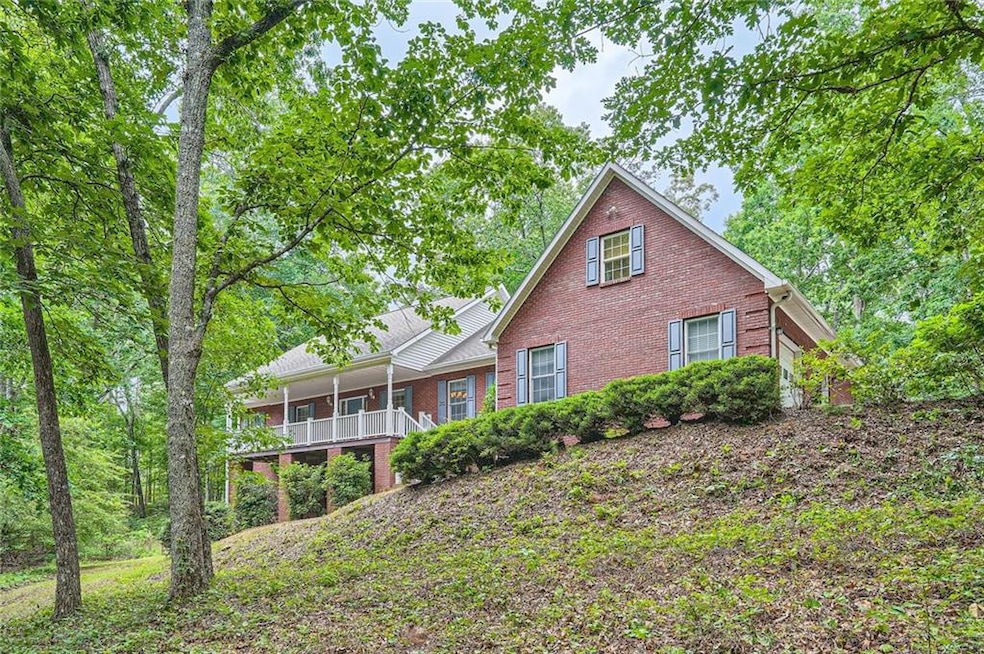 Rear view of house featuring brick siding and covered porch