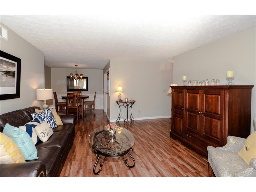 Welcoming living room overlooks dining area and su