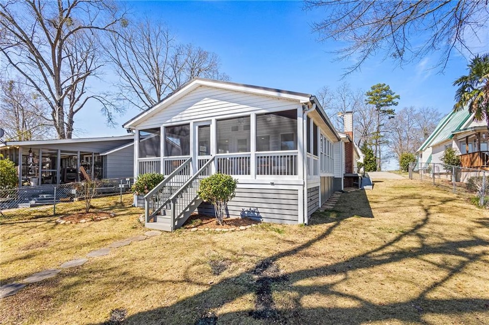 Back of house featuring stairway, a yard, a chimne