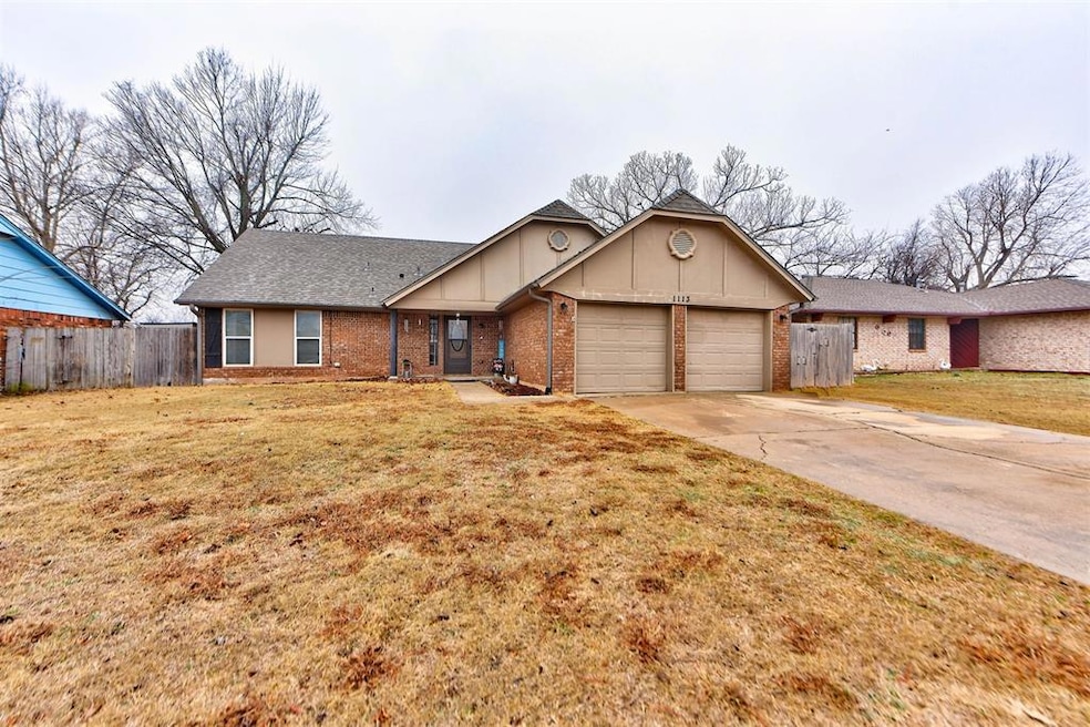 Ranch-style home with a garage and a front lawn