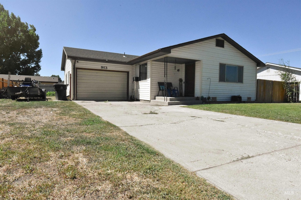 Ranch-style home featuring concrete driveway and a garage