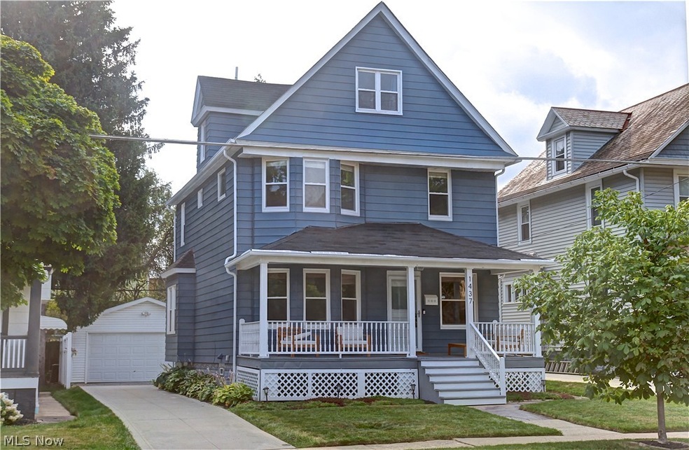 View of front of home with a garage, a porch, an outdoor structure, and a front yard