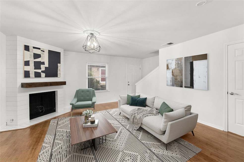 Living area featuring wood finished floors, a cha