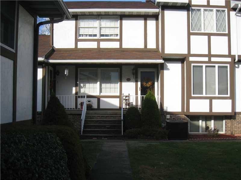 Exterior Front. Covered front porch, view of court