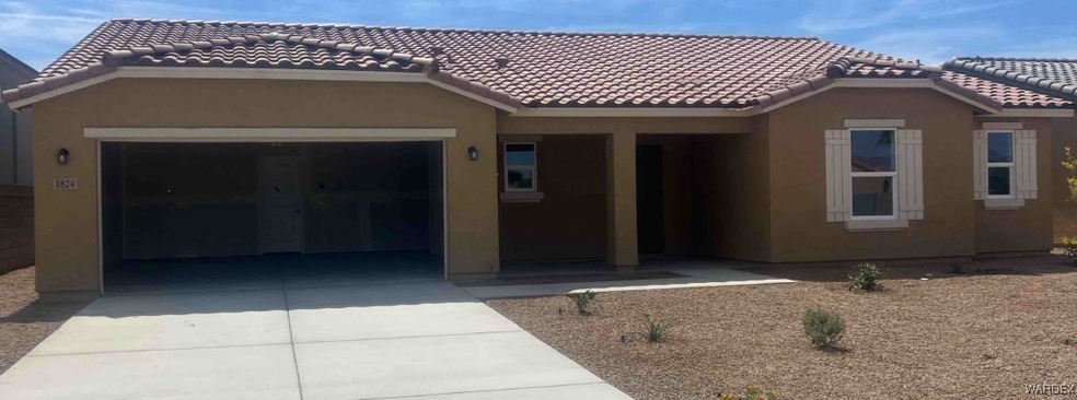 View of front of house with stucco siding, a garag