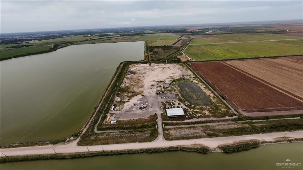Aerial overview of property's location with a nearby body of water and rural landscape