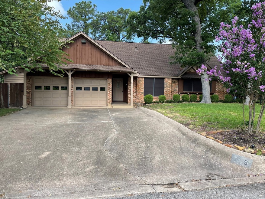 Front of home with extra wide driveway.
