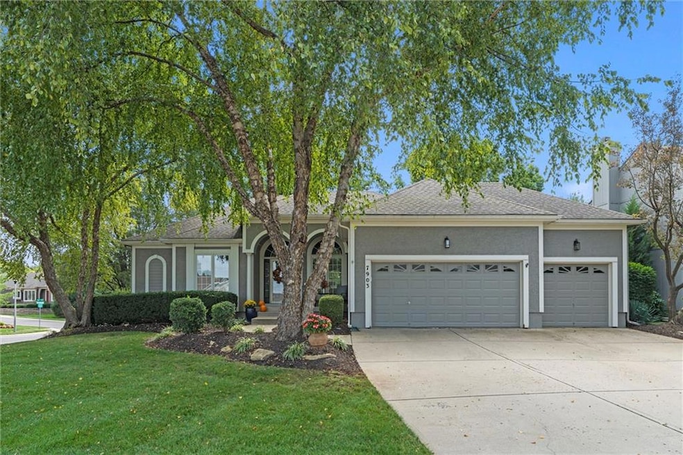 View of front of home featuring an attached garage, concrete driveway, a front lawn, a shingled roof, and stucco siding