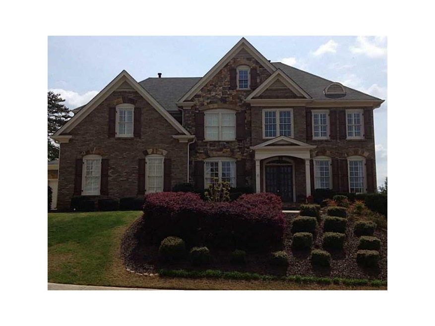 Exterior Front. Stone and Brick 3 sides with annua