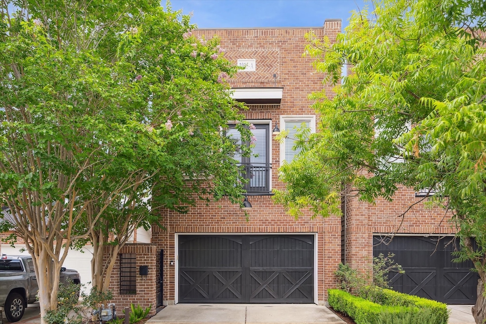 Brick-clad façade with black carriage-style garage