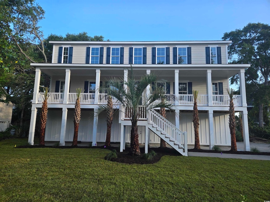 View of front of house featuring stairs, a porch, and a front yard
