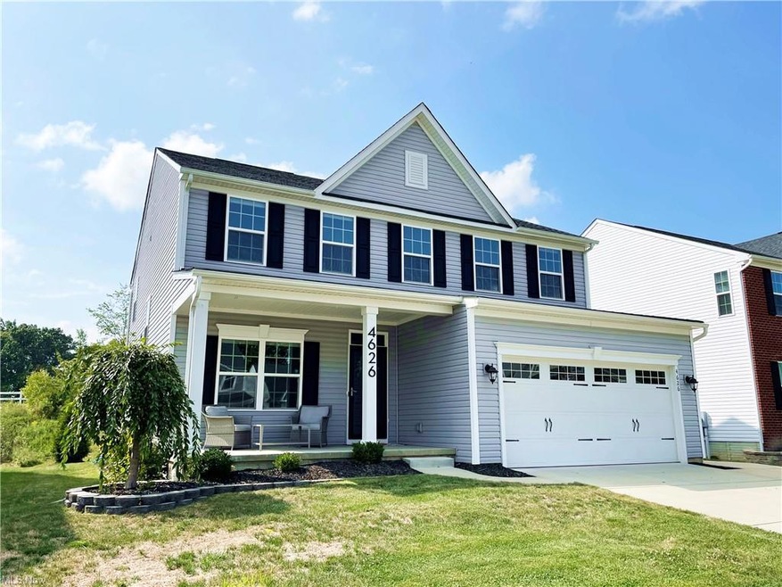 View of front of home with garage, a porch, and a 
