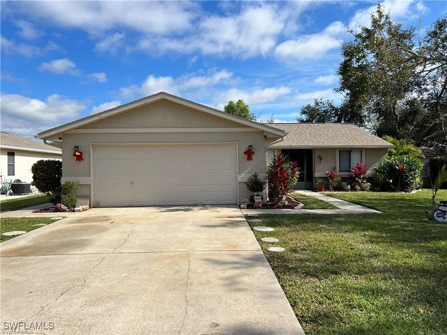 Ranch-style home featuring cooling unit, a front y