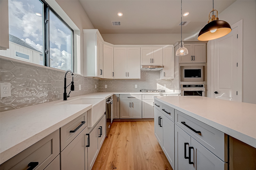 This modern kitchen features sleek white cabinetry