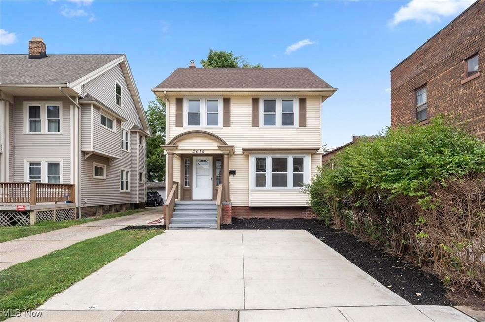 View of front of house featuring a wooden deck