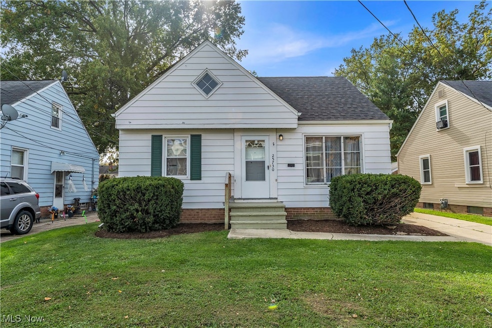 Bungalow-style house with a front yard, roof with shingles, and entry steps