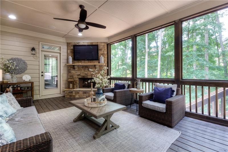 Outdoor living at its best. Wood burning outdoor fireplace, screened outdoor room, and adjacent open air porch for grilling. Beautiful wooded view and large private and fenced back yard..